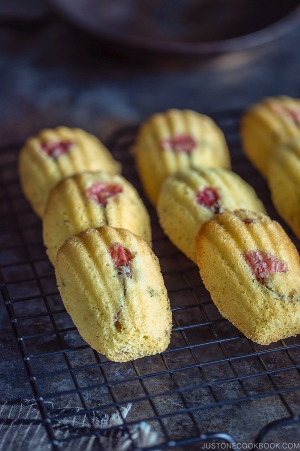 Cherry Blossom Madeleines laid staggered on a wire rack.