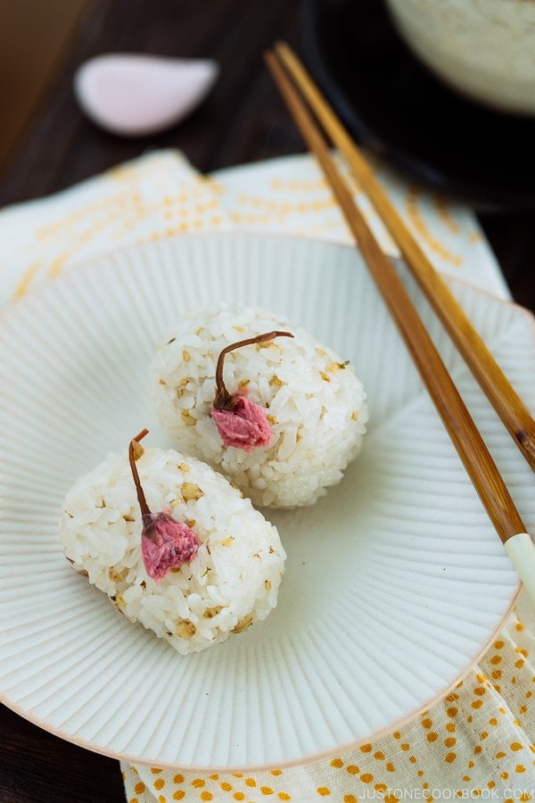 Cherry Blossom Rice Balls on a white ruffled plate.