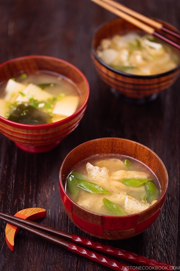 Three kinds of vegetable miso soups, each served in a wooden bowl.