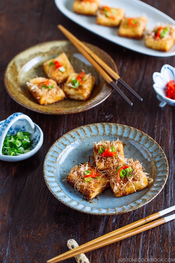 Three pieces of Teriyaki Tofu are placed on a Japanese blue plate | Easy. Japanese Recipes at JustOneCookbook.com