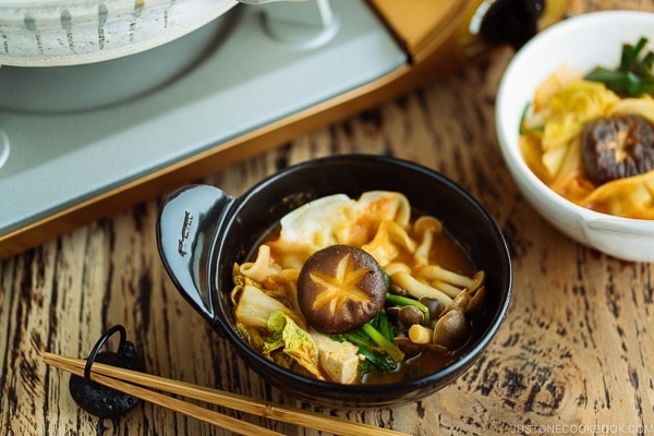 Kimchi Gyoza Nabe served in donabe (Japanese earthenware pot).