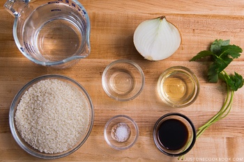 ingredients for sweet onion takikomi gohan on wood cutting board