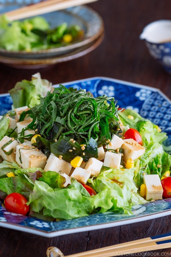 Refreshing Tofu Salad with Sesame Ponzu Dressing on a Japanese blue platter.