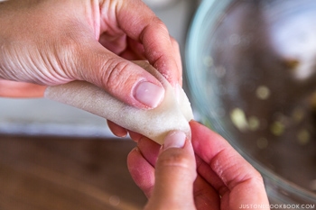 fingers making gyoza with gyoza wrapper