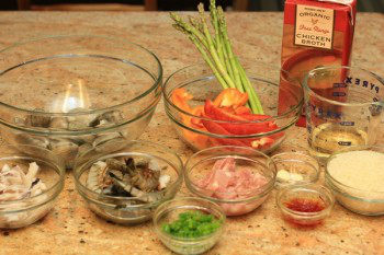 Paella ingredients on top of a granite countertop