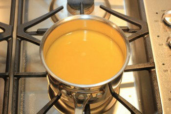 chicken stock in a metal pan on top of stove