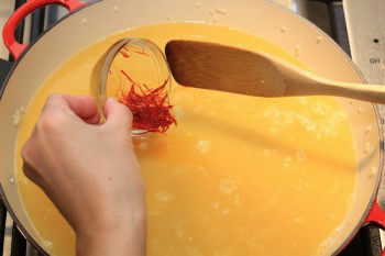 saffron added to mixture inside metal pan