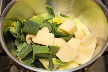 potato and leek pieces in a pan on the stove top