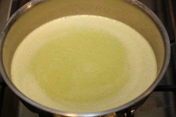 potato and leek soup inside a metal pan with salt and pepper