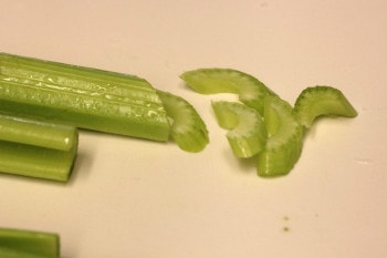celery sliced diagonally on cutting board