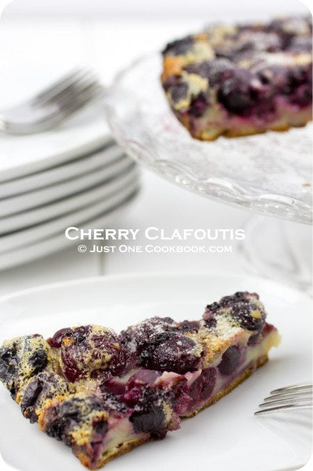 Cherry Clafoutis on a plate and a cake stand.