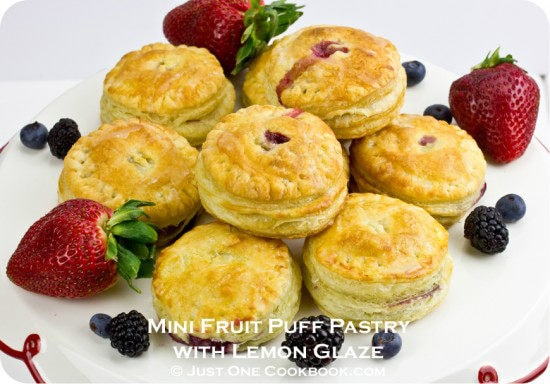 Mini Fruit Puff Pastry with Lemon Glaze and berries on a plate.