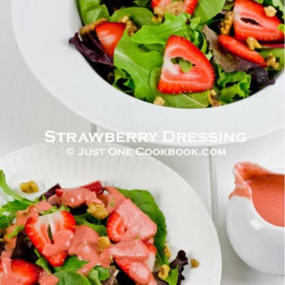 strawberry salad with dressing in white bowls on top of whiteboard