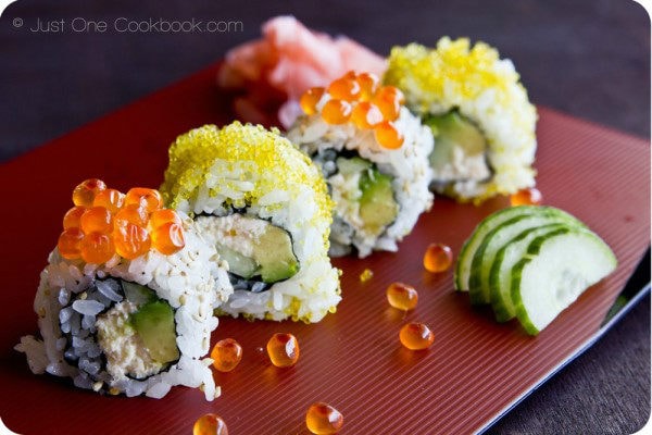 California Roll and ikura on a red plate.