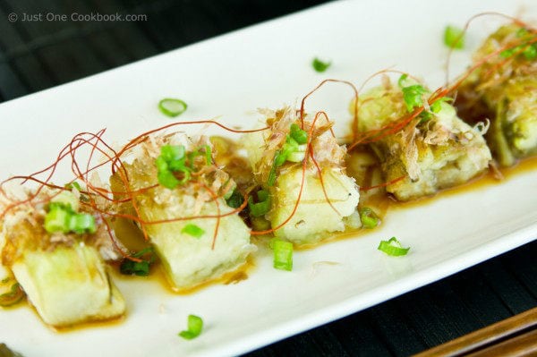 Japanese Grilled Eggplant (Yaki Nasu) on a white plate.