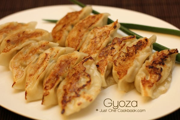 Gyoza on a white plate.