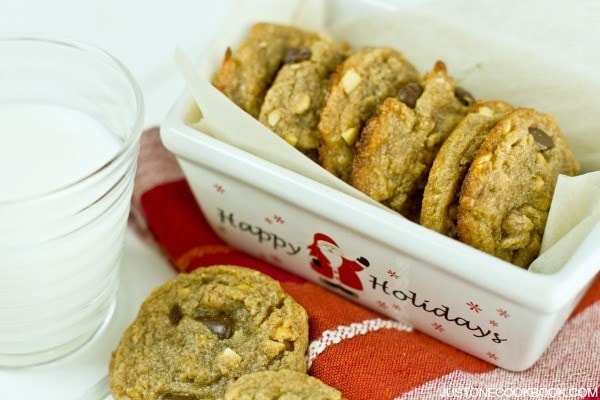 Peanut Butter Chocolate Chip Cookies in a holiday dish and a glass of milk.