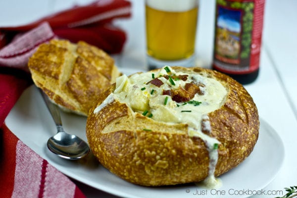 Thomas Keller’s Clam Chowder Recipe | JustOneCookbook.com Thomas Keller’s Clam Chowder in a bread bowl and a glass of beer on a side.