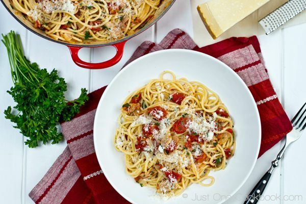 Tomato Bacon Pasta on a plate with parsley and cheese.