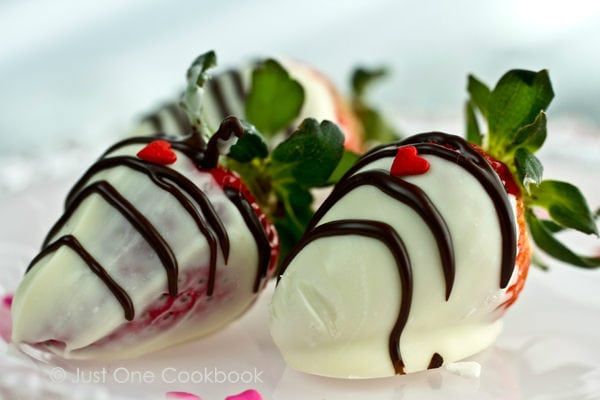 Chocolate Covered Strawberries with little red hart decoration. 
