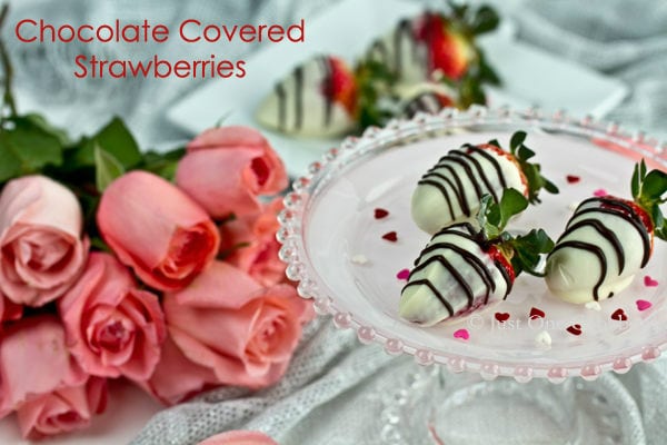 Chocolate Covered Strawberries Recipe | JustOneCookbook.com Chocolate Covered Strawberries on a cake stand and pink roses.
