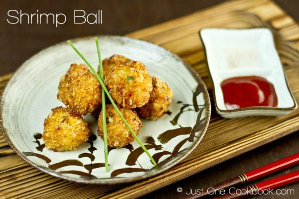  Deep Fried Shrimp Ball on a plate and sauce on a side.