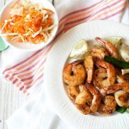 Honey Glazed Shrimps with Asian Coleslaw and Rose Cake in a white plate on top of white towel