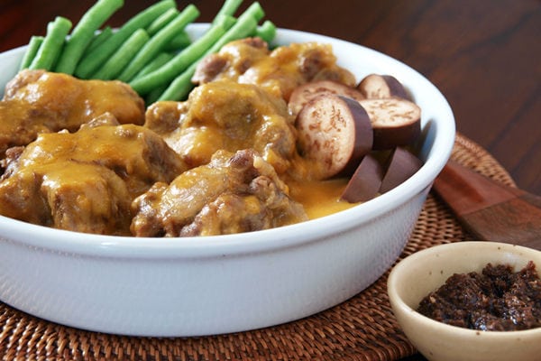 Kare Kare with string beans and eggplants in a plate.