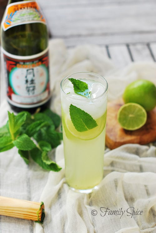 Sake Mojito in a tall glass and ingredients on a side.