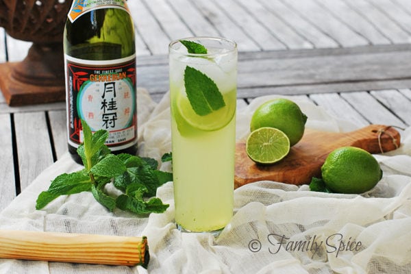 Sake Mojito in a glass and ingredients on a side. 