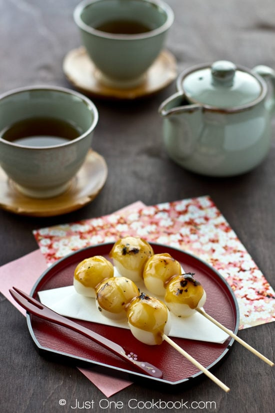 Mitarashi Dango on a small plate and cup of tea.