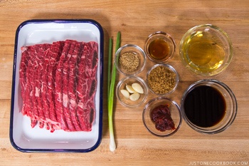 ingredients for bbq short ribs on wood cutting board