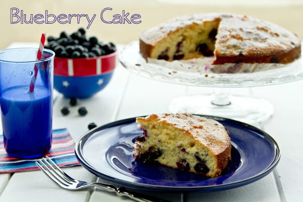 Blueberry Cake on a plate and cake stand.