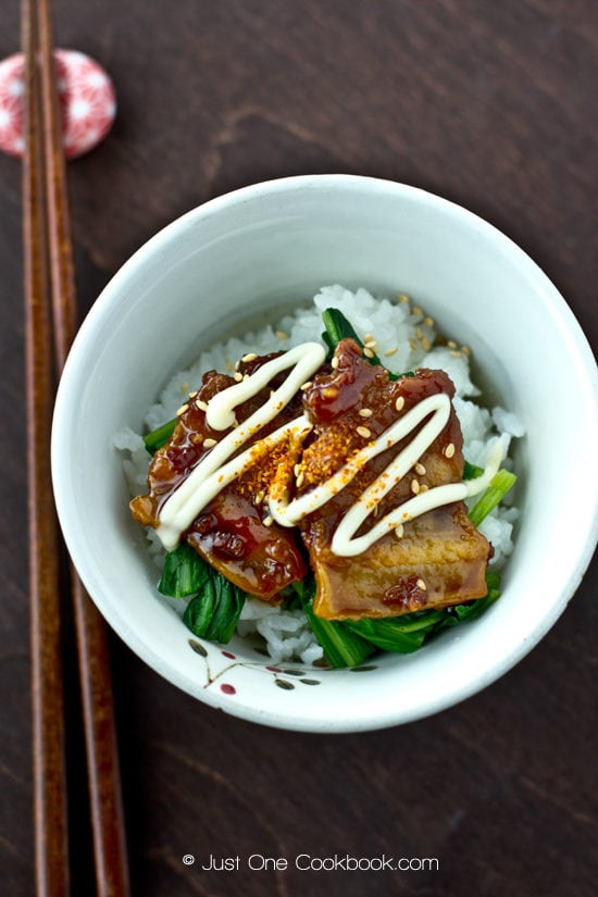 Honey Pork Belly with spinach and Japanese mayo over a bowl of white rice.