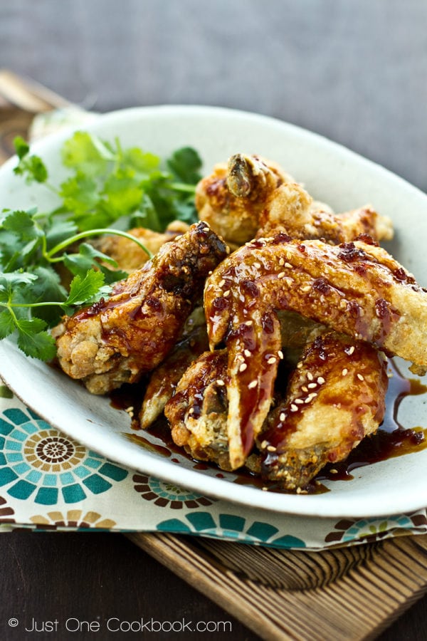 Nagoya Style Fried Chicken Wings coated with savory sweet garlic soy dressing on a white plate.