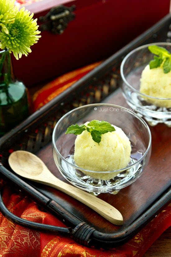 Pineapple Sorbet in glass cups on a wooden tray.