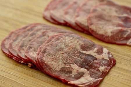 Beef Tongue Beef Tongue on a cutting board.