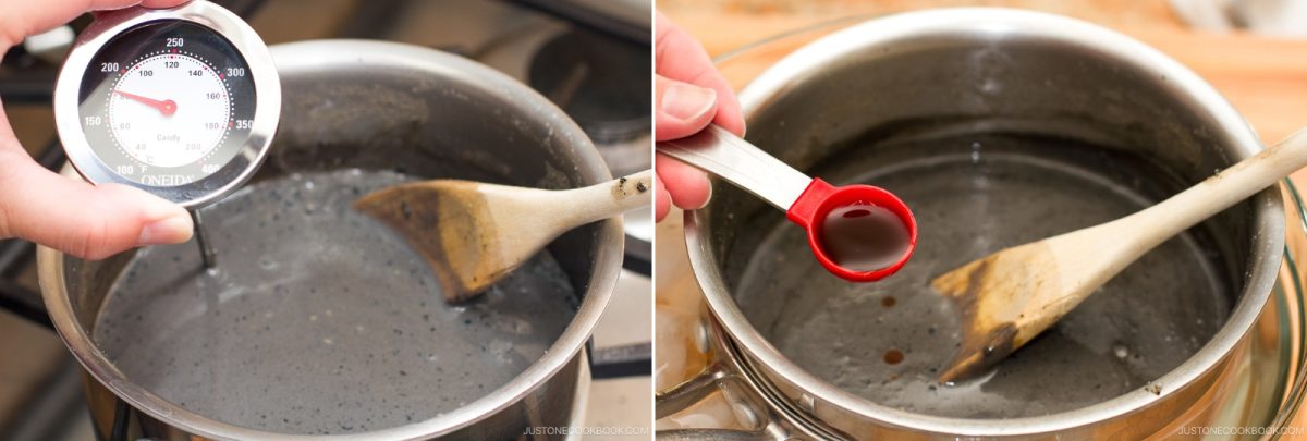 A person checks the temperature of a gray liquid in a pot with a thermometer, carefully preparing the base for black sesame ice cream, then adds a teaspoon of brown liquid to the mixture while stirring with a wooden spoon.