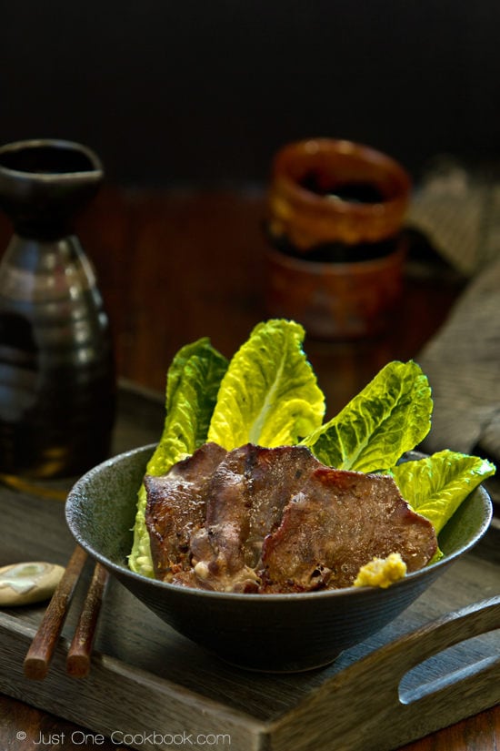 Gyutan (BBQ Beef Tongue) Gyutan in a bowl and sake on a table.