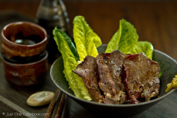 Gyutan (BBQ Beef Tongue) Gyutan in a bowl and sake cups on a table.
