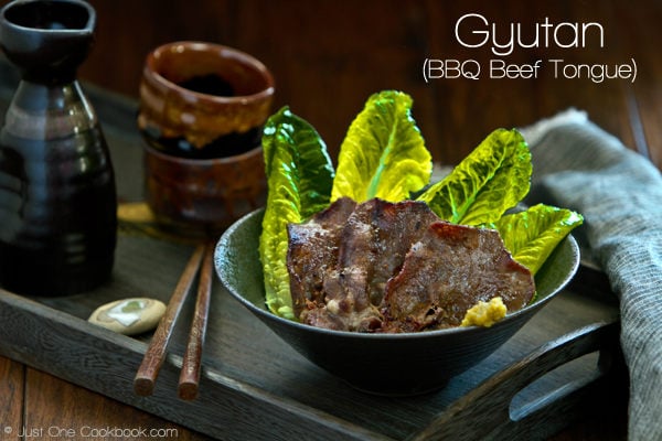 Gyutan | BBQ Beef Tongue Recipe | JustOneCookbook.com Gyutan, BBQ Beef Tongue in a bowl and sake bottle on a side.