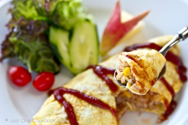 Omurice, Japanese Omelette Rice with salad on a plate.