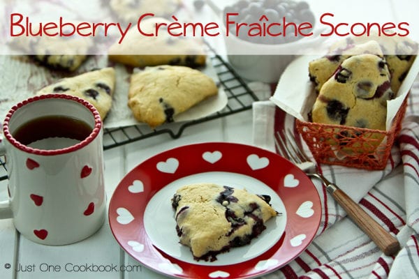 Blueberry Crème Fraîche Scones on a plate and a cup of coffee.