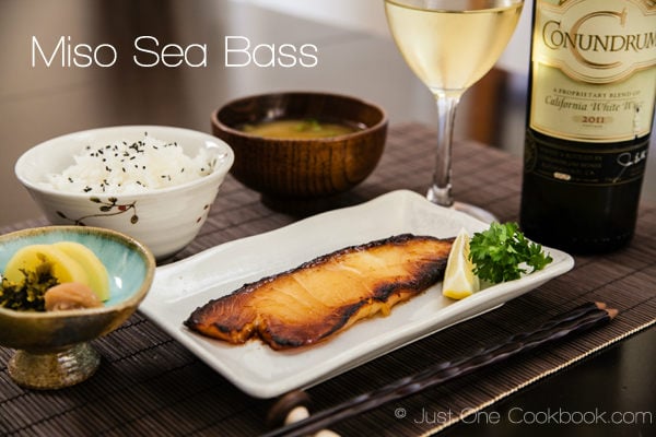 Miso Sea Bass, rice, pickled, and miso soup on a table.