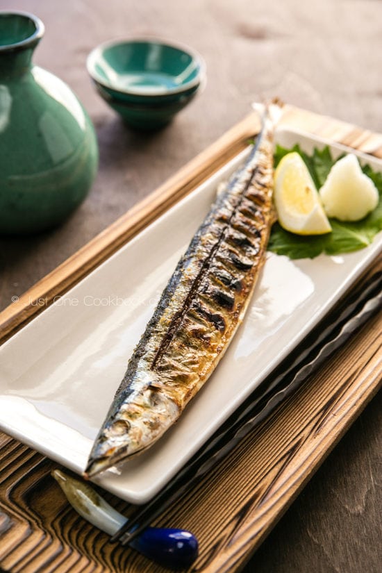 Grilled Sanma, daikon and lemon on a plate.