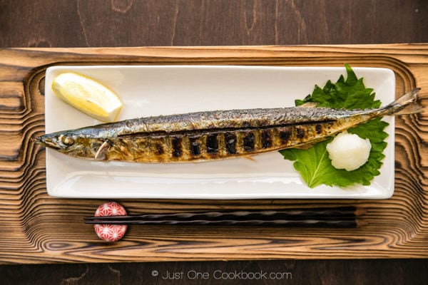 Grilled Sanma on a white dish.