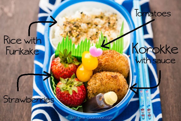 Korokke Bento with rice, tomatoes and strawberries. 