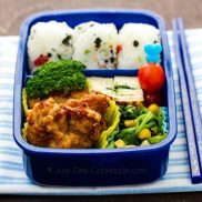 Karaage Bento with tamagoyaki, broccoli, tomato, spinach sautee, and Onigiri.