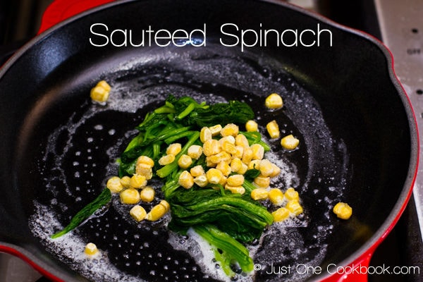 Sauteed Spinach with corn in a pan.