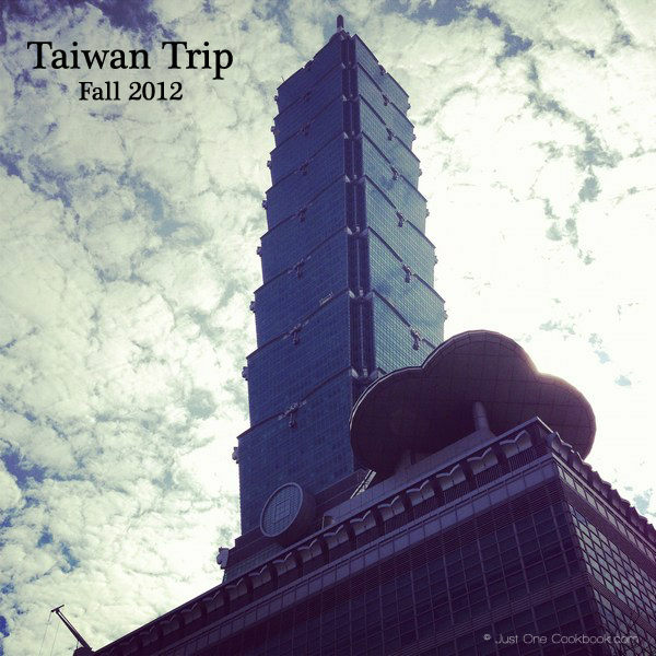 view of taipei 101 from the bottom with clouds in the background 